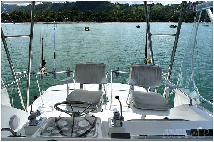 Bedroom with queen size bed and table lamps on boat