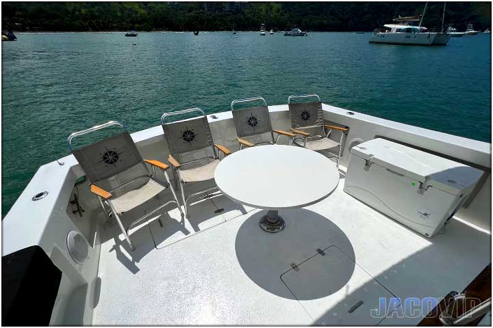 Bedroom with queen size bed and table lamps on boat