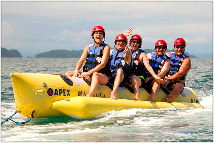 People on banana boat with helmets and life jackets