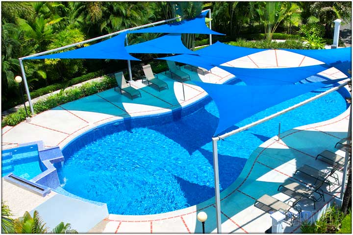 View of pool and blue triangles for shade