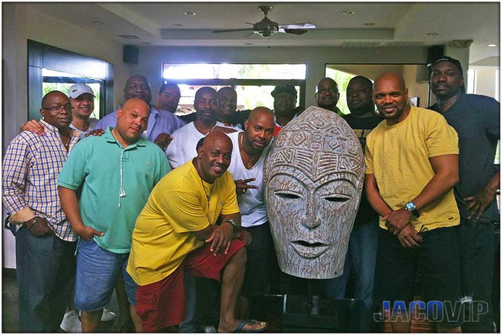 Bachelor party group standing next to large mask