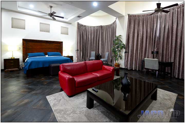 living area in master suite with sofas coffee table and large TV