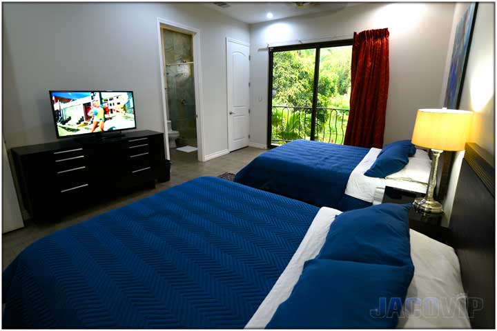 Bedroom with patio doors and mountain views