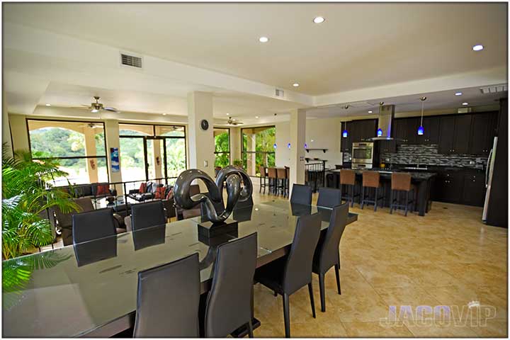 Large dining table facing the open kitchen area