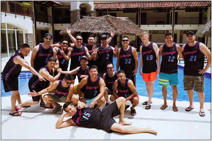 Bachelor party group posing inn front of the pool