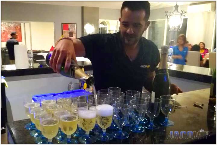 Jaco VIP bartender service pouring champagne for private party