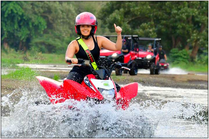 Goirl giving thumbs up on ATV