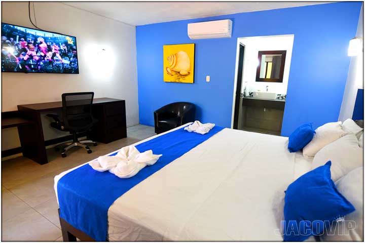 Comfortable Bedroom with blue wall and blue accent pillows