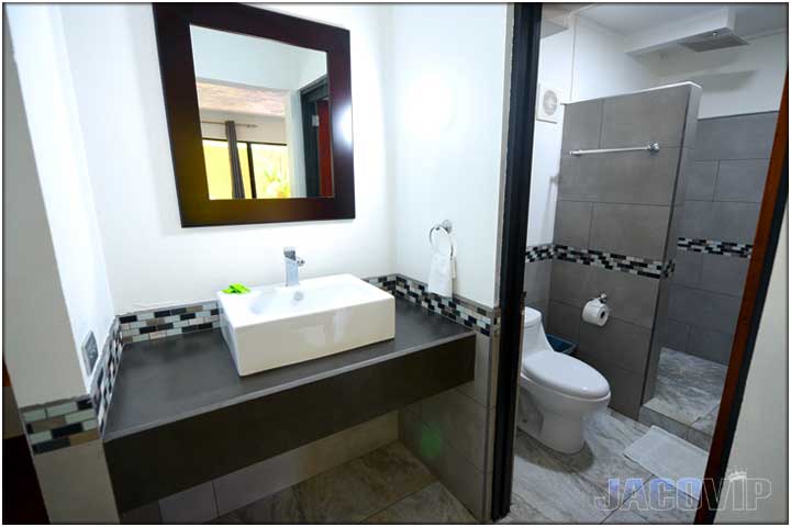 Bathroom with rectangle shape sink and grey counters