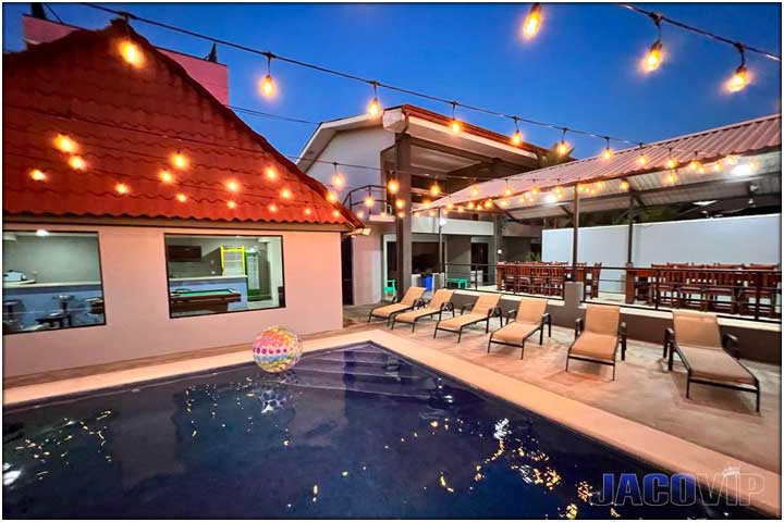 Swimming pool and rancho area with view of main building