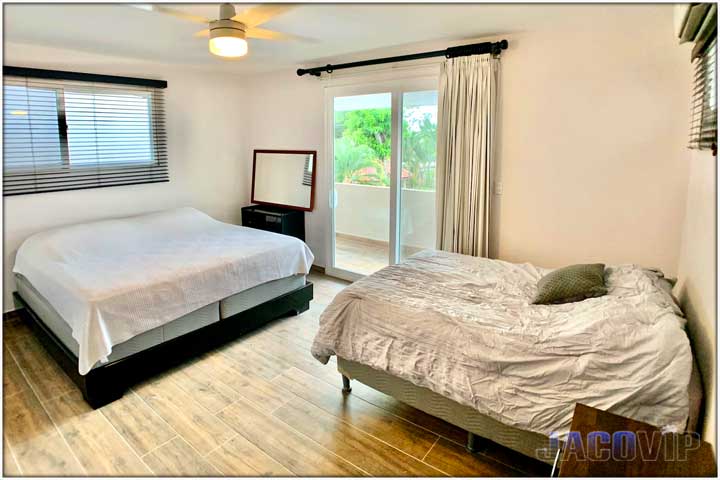 Wide angle of two beds in bedroom