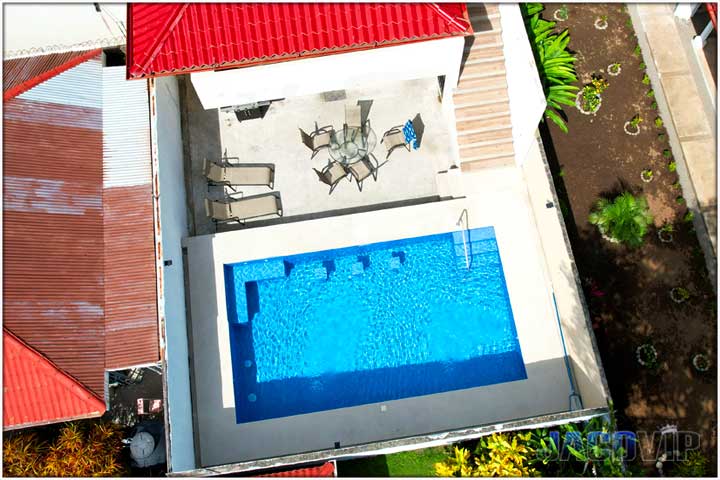 Overhead drone view of swimming pool and terrace