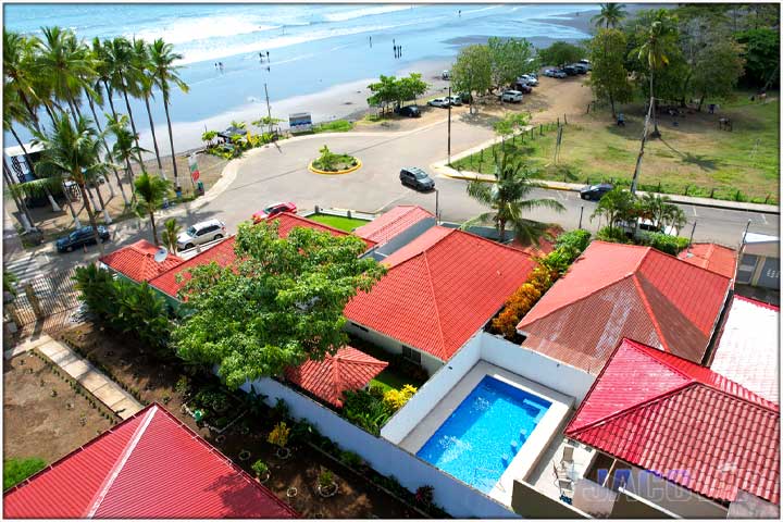 Aerial drone view of Casa Impala pool and Jaco Beach