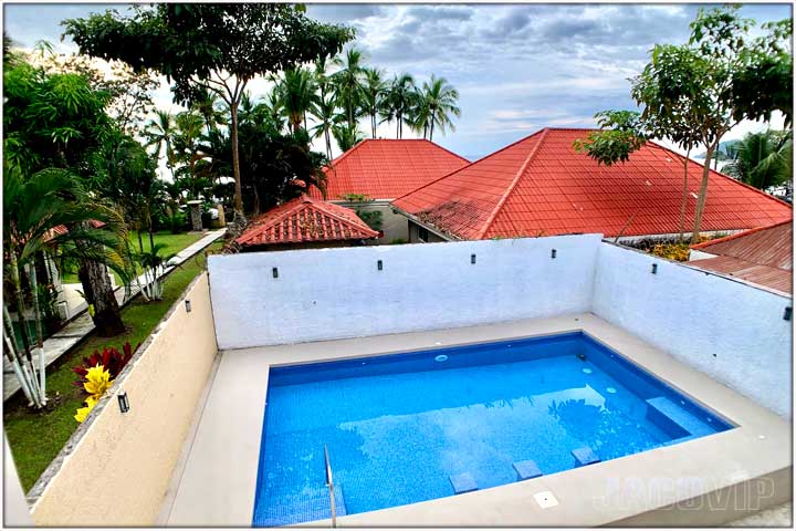 View of pool at Casa Impala with glimpse of Jaco Beach and pacific ocean