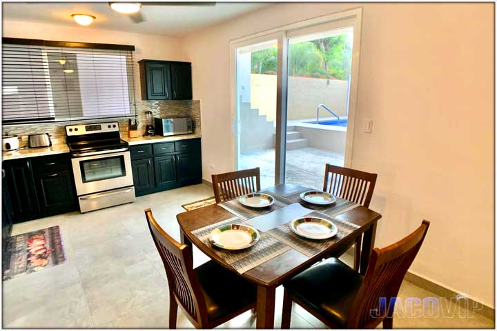 Breakfast table ad sliding glass doors leading out to pool area