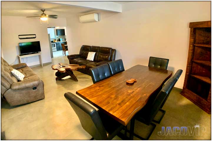 Exotic hard wood table and 6 leather chairs in living room area