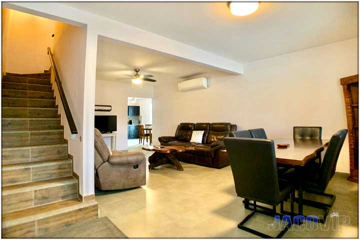 Living room and stair case leading up to second floor