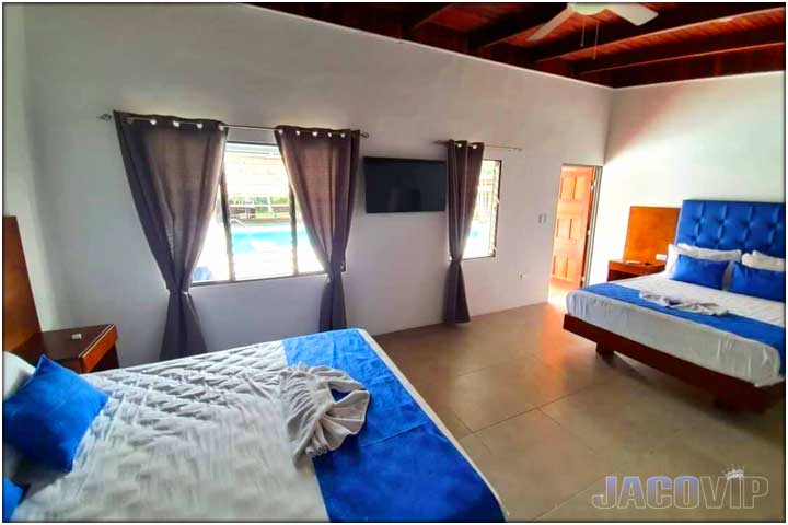 View of queen size bed, TV and window