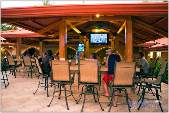 Pool bar during the day with some people at bar