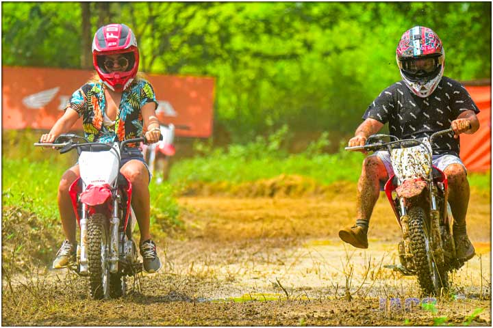 Girl driver and boy driver on mini dirt bikes