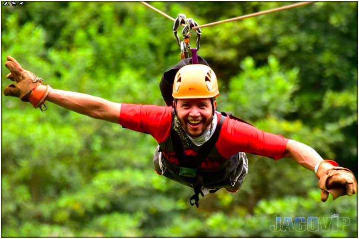 Guy on zpline with arms open