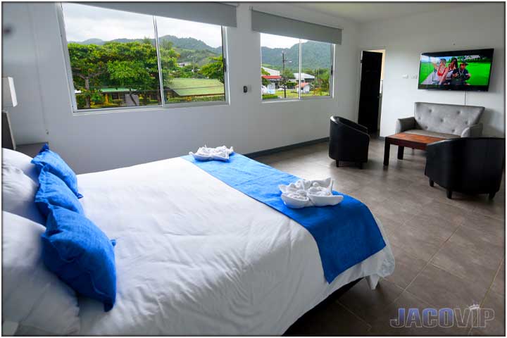 Bedroom with sitting area and tv