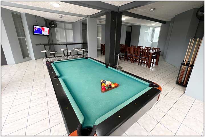 Pool table with blue green carpet