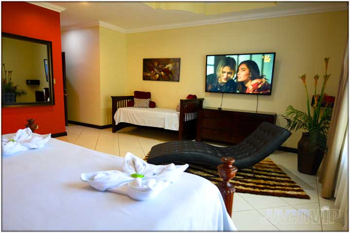 corner view of bedroom with large tv