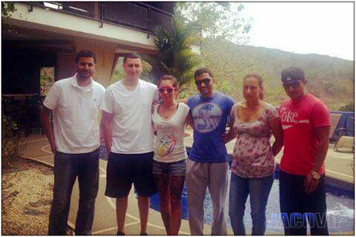 family group in front of pool