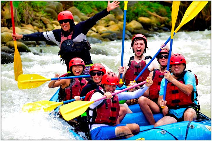 Rafting guide with arms open posing for camera