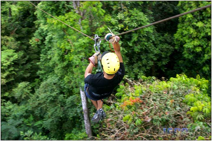 Guy on zipline with yellow helmet